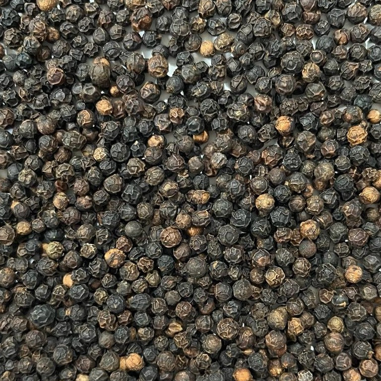 close-up of black peppercorns Apotheka Herbal